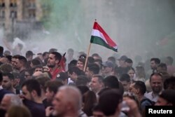 People attend an anti-government protest in Budapest, Hungary, on April 6, 2024.