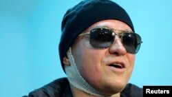 Sergei Filin, artistic director of Russia's Bolshoi Ballet, speaks to journalists as he leaves a hospital in Moscow, Feb. 4, 2013.