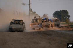 A column of armored Israeli army vehicles drives in southern Israel near the Gaza border on Feb. 16, 2024.