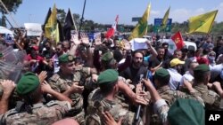 Hezbollah supporters scuffle with Lebanese army soldiers while protesting the visit by Gen. Frank McKenzie, the head of U.S. Central Command, outside ​​the Rafik Hariri International Airport in Beirut, Lebanon, July 8, 2020.