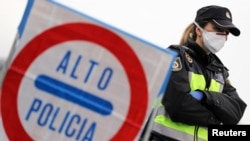 A border officer stands at the last toll gate entering Spain from France, following an order from the Spanish government to set up controls at its borders in response to the coronavirus, in La Jonquera, Spain, March 17, 2020. 