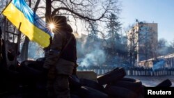 Tourists enjoy a sunny day as they cruise the Vltava river in a pedal boat near the famous Charles bridge in Prague, Czech Republic.