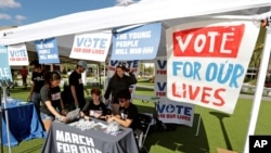 student volunteers help out at a booth to encourage on campus voting for students during a Vote for Our Lives event at the University of Central Florida in Orlando, Fla. in 2018.
