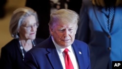 FILE - U.S. President Donald Trump flashes a thumbs-up as he arrives at the World Economic Forum in Davos, Switzerland, Jan. 22, 2020.