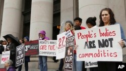 FILE - People opposed to child sex trafficking rally in Washington, Oct. 21, 2014.