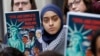 Demonstrators listen during a rally outside the 4th Circuit Court of Appeals, Jan 28, 2020, in Richmond, Va. President Donald Trump's travel ban on travelers from predominantly Muslim countries is going back before a federal appeals court.