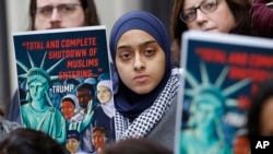 Demonstrators listen during a rally outside the 4th Circuit Court of Appeals, Jan 28, 2020, in Richmond, Va. President Donald Trump's travel ban on travelers from predominantly Muslim countries is going back before a federal appeals court.