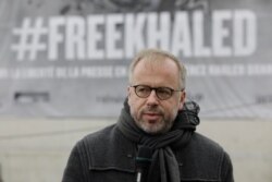 Christophe Deloire, head of Reporters Without Borders, is pictured in front of a giant portrait of Algerian journalist Khaled Drareni, in Paris, Oct.15, 2020.