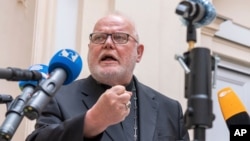 FILE - Cardinal Reinhard Marx, Archbishop of Munich and Freising, gives a statement to the press in the courtyard of his residence in Munich, June 4, 2021.