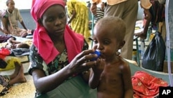 A severely malnourished Somali child receives Oral Rehydration Salts at Mogadishu's Banadir hospital on July 28, 2011
