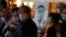 People wearing masks, attend a vigil for Chinese doctor Li Wenliang, in Hong Kong, Friday, Feb. 7, 2020. 
