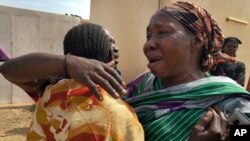 Relatives of the six aid workers who were killed grieve as they wait outside a morgue in Juba, South Sudan, March 27, 2017. 