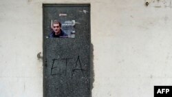 FILE - A poster is pasted on a door calling for the release of one of the most influential leaders of former Basque separatist group ETA, Josu Ternera, in the Spanish Basque village of Miraballes, May 16, 2019, after he was arrested in France. 