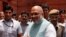 FILE - India's newly appointed Home Minister Amit Shah greets the media upon his arrival at the home ministry in New Delhi, India, June 1, 2019.
