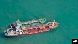 FILE - This May 24, 2018, photo released by Japan's Ministry of Defense shows North Korean-flagged tanker SAM JONG 2, bottom, alongside MYONG RYU 1, a vessel of unknown nationality, in the East China Sea. Japan's Foreign Ministry said a Japanese navy surveillance aircraft spotted a suspected unidentified ship apparently transferring fuel to a North Korean tanker in the open seas.