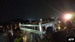 Residents carry the coffin of a suicide attack victim in the port city of Gwadar on August 20, 2021.