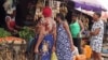 Women are shopping at a market in Abuja, Nigeria, in this screen grab taken from video.
