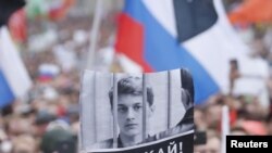 A supporter of student and blogger Yegor Zhukov, who was detained during a recent protest for fair elections, holds a placard during a rally to demand authorities allow opposition candidates to run in the local election in Moscow, Russia.