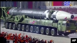 This image made from video broadcasted by North Korea's KRT, shows a military parade with what appears to be a possible new intercontinental ballistic missile at the Kim Il Sung Square in Pyongyang, Saturday, Oct. 10, 2020. (KRT via AP)