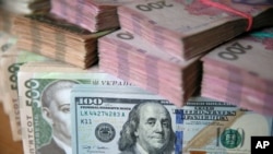U.S. dollar and Ukrainian hryvnia bills are seen in this picture illustration taken in Kyiv, Ukraine, Oct. 31, 2016.