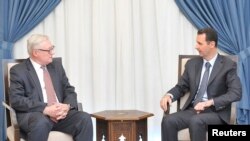 A woman walks past electoral campaign posters for the upcoming parliamentary elections in Tunis, Tunisia.
