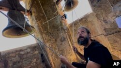 Joan Carles Osuna, a student of the Vall d'en Bas School of Bell Ringers, performs playing all four bronze bells at the church bell tower of the12th-century Sant Romà church, at the village of Joanetes, about two hours north of Barcelona, Spain, June 29, 2024. 