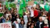 People hold banners and dance during a Climate Change March demanding politicians take tougher action to protect the climate in Berlin, Sept. 21, 2014. 