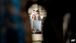 FILE - Girls sit in their classroom on the first day of the new school year, in Kabul, Afghanistan, March 25, 2023. 