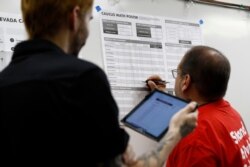 A precinct leader records votes at a caucus location at Coronado High School in Henderson, Nevada, Feb. 22, 2020.
