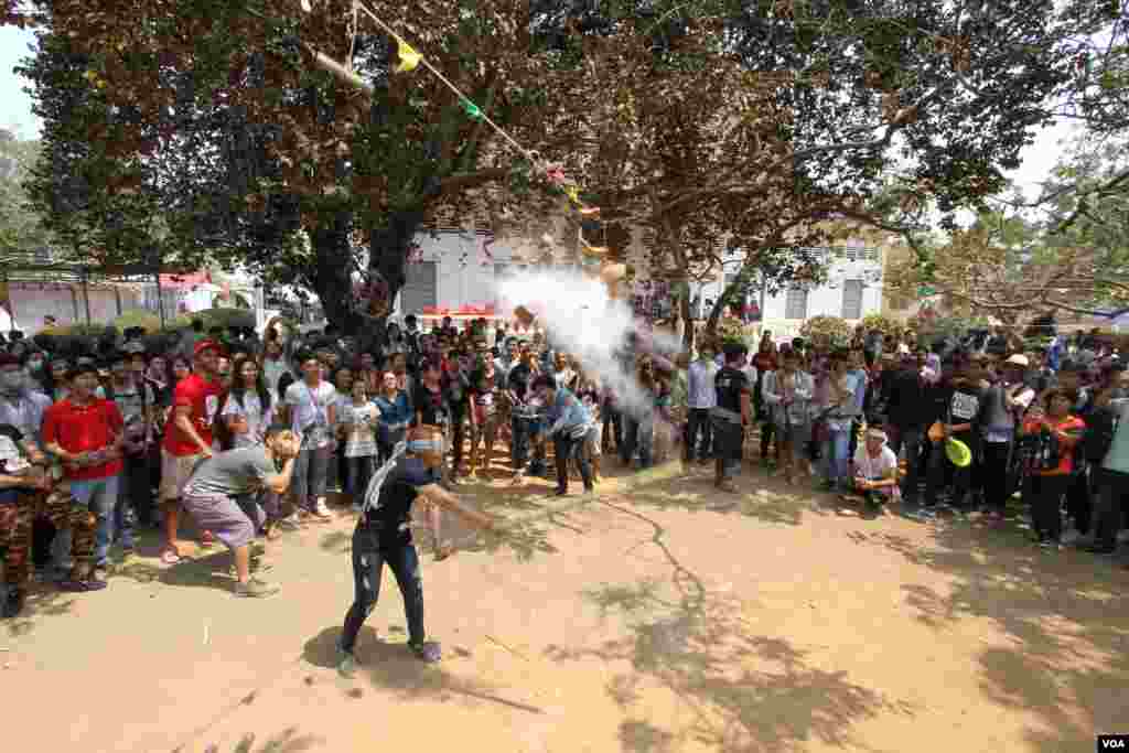 យុវជនខ្មែរមួយករូបលេងល្បែងវាយក្អមក្នុងពិធីមួយដើម្បីប្រារព្ធចូលឆ្នាំខ្មែរនៅវត្តជ្រោយអំពិលខ័ណ្ឌច្បារអំពៅរាជធានីភ្នំពេញកាលពីថ្ងៃសៅរ៍ទី០៩ខែមេសានេះ។ ប្រជាជនខ្មែរប្រារព្ធពិធីបុណ្យចូលឆ្នាំខ្មែរចាប់ពី ថ្ងៃទី ១៣ដល់ទី១៦ខែមេសាឆ្នាំ២០១៦នេះ នៃ​ឆ្នាំ​វក សត្វ​ស្វា។ (ឡេង ឡែន/VOA)​