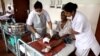 Nurses are dressing а wound on leprosy patient Gopal Bag, following amputation of his leg, at the Leprosy Mission Trust India hospital, Kolkata, Sept. 20 2016. (M. Hussain/VOA) 