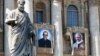 The tapestries of Roman Catholic Archbishop Oscar Romero, left, and Pope Paul VI hang from a balcony of the facade of St. Peter's Basilica at the Vatican, Oct. 13, 2018. Pope Francis will canonize two of the most important and contested figures of the 20th-century Catholic Church Sunday.