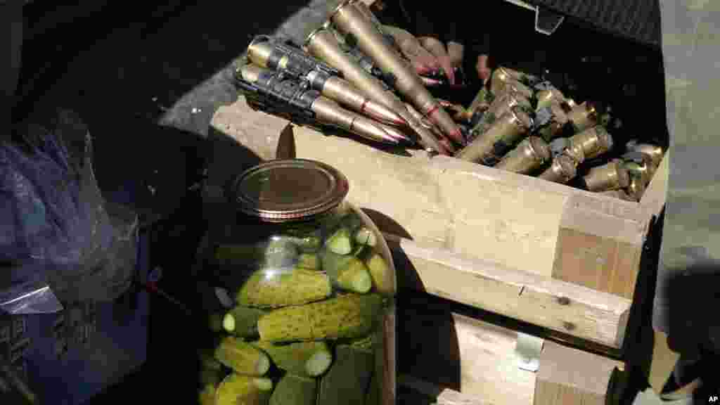 Canned cucumbers and heavy machine gun ammunition are seen in a Pro-Russian rebel's car in Donetsk, eastern Ukraine, Sept. 7, 2014. 