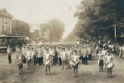 In this July 4, 1910 photo made available by the Library of Congress, United Confederate Veterans from the Civil War march with drummers down a street in Petersburg, Va.