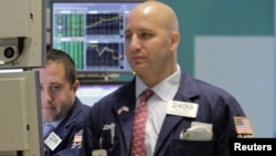 Traders work on the floor of the New York Stock Exchange, September 6, 2012. 