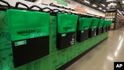 Reusable shopping bags are displayed inside an Amazon Go Grocery store set to open soon in Seattle's Capitol Hill neighborhood, Feb. 21, 2020.