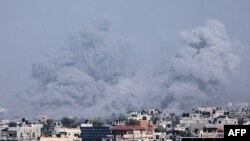 A picture taken from Rafah shows smoke billowing over Khan Yunis in the southern Gaza Strip during Israeli bombardment on January 9, 2024.