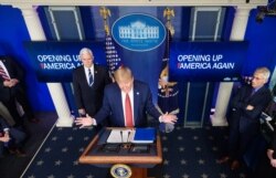U.S. President Donald Trump, flanked by U.S. Vice President Mike Pence and Director of the National Institute of Allergy and Infectious Diseases Anthony Fauci, right, speaks in the Brady Briefing Room of the White House, April 16, 2020.