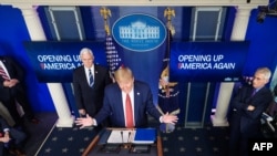 President Donald Trump, flanked by U.S. Vice President Mike Pence and Director of the National Institute of Allergy and Infectious Diseases Anthony Fauci, right, speaks on the coronavirus in the Brady Briefing Room of the White House, April 16, 2020.