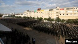 Cambodia's armed forces display anti-riot gear and assault rifles at the Olympic stadium ahead of a general election this weekend, in Phnom Penh, Cambodia, July 25, 2018. REUTERS/Samrang Pring