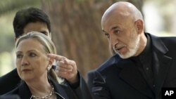 US Secretary of State Hillary Rodham Clinton, left, walks with President of Afghanistan Hamid Karzai to a press conference at the Presidential Palace in Kabul Saturday July 7, 2012.