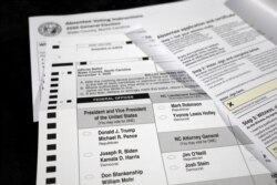 FILE - An absentee ballot and required paperwork await preparations at the Wake County Board of Elections on the first day that the state started mailing them out, in Raleigh, N.C., Sept. 4, 2020.