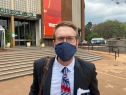 David Coltart of Zimbabwe Lawyers for Human Rights representing journalist Hopewell Chin’ono talks to the media Nov. 12, 2020, after his client was denied bail at the Magistrates Court in Harare. (Columbus Mavhunga/VOA)