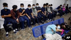 Young unaccompanied migrants wait for their turn at the secondary processing station inside the U.S. Customs and Border Protection facility, the main detention center for unaccompanied children in the Rio Grande Valley, in Donna, Texas, March 30, 2021.