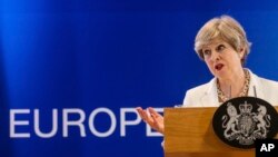 FILE - British Prime Minister Theresa May speaks during a media conference in Brussels, June 23, 2017. May's government is trying to negotiate a trade deal with the EU but Europe wants it to set terms for its leaving the group. 