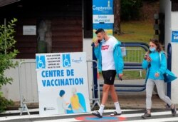 Residents leave a vaccination center in Capbreton, southwestern France, June 24, 2021. The delta variant, first identified in India, is estimated to represent 9 to 10% overall in France.