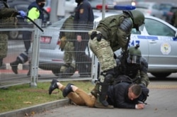 Police detain a man during an opposition rally to protest the official presidential election results in Minsk, Belarus, Nov. 1, 2020.