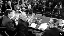 Chairman Peter Rodino, D-N.J., of the U.S. House Judiciary Committee,center, chief counsel John Doar, left, and minority counsel Albert Jenner, right, gather in Washington, March 5, 1974. Doar presented a status report on the panel's investigation to impeach President Nixon.