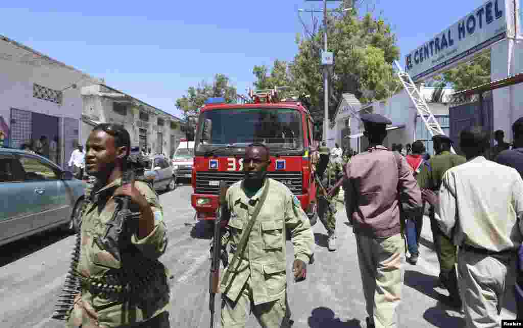 Somali security agents are seen outside the Central Hotel after a suicide attack in Somalia&#39;s capital Mogadishu.