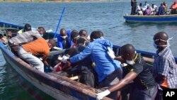 Rescuers retrieve a body from the water near Ukara Island, in Lake Victoria, Tanzania, Sept. 21, 2018, after the passenger ferry MV Nyerere capsized.